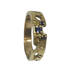 Gold ring with blue gemstones on a white background