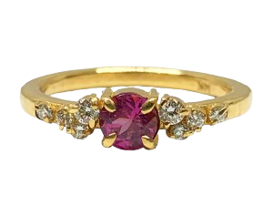 Gold ring with a red gemstone and small diamonds on a white background